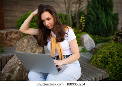 Cute Young Female Student Sitting With Laptop On Lunch Break Sitting Outside