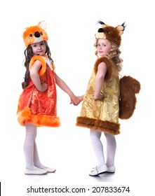 Cute young friends posing in carnival costumes
