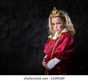 Cute Young Girl Dressed Up In A Princess Costume On A Black Background.