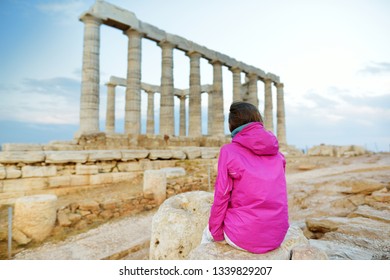 Cute Young Girl Exploring The Ancient Greek Temple Of Poseidon At Cape Sounion, One Of The Major Monuments Of The Golden Age Of Athens.