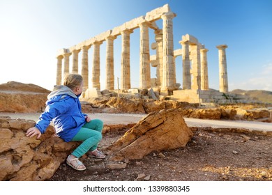 Cute Young Girl Exploring The Ancient Greek Temple Of Poseidon At Cape Sounion, One Of The Major Monuments Of The Golden Age Of Athens.