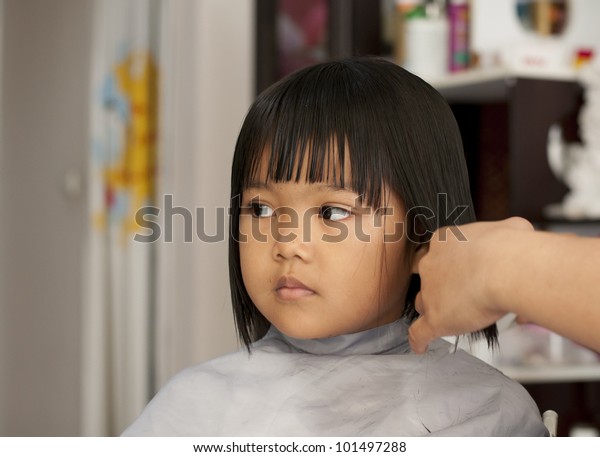 Cute Young Girl Getting Haircut Before Stock Image