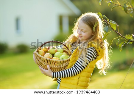 Similar – Image, Stock Photo Little girl woman carrying wicker basket with fresh organic apples