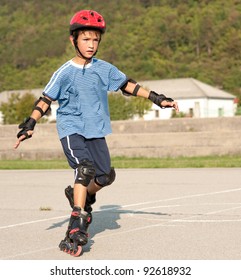 Cute Young Girl Rollerskates On A Playground