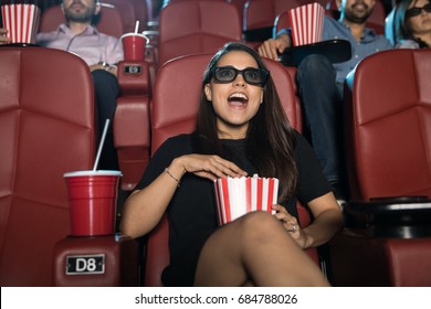 Cute Young Hispanic Woman Looking Surprised And Excited At The Movie Theater While Watching A 3d Film
