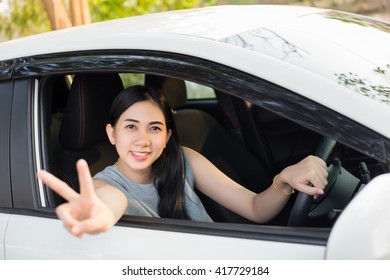 Cute Young Lady Happy Driving Car