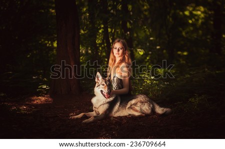 Cute young lady sitting with grey dog