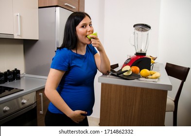 Cute Young Pregnant Woman Eating Apple And Slicing Food 