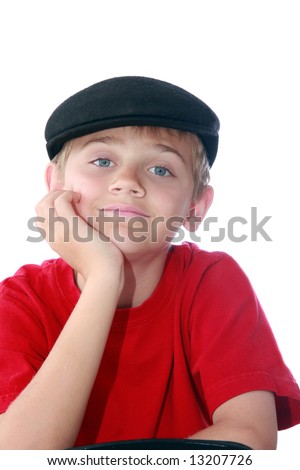 cute young tween boy wearing paperboy cap and red shirt, isolated on white.
