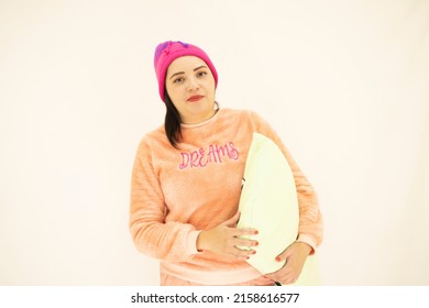 Cute Young White Asian Woman Wearing Pink Pajamas And A Night Cap, Ready To Sleep While Holding A Pillow, On White Background