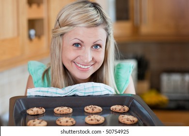 Cute Young Woman Baking Cookies In The Kitchen