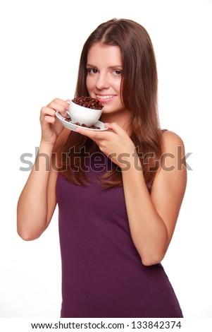 Cute young woman with cup of coffee beans
