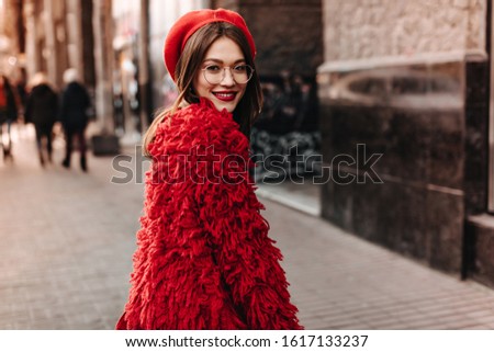 Similar – Woman Walking Through Building