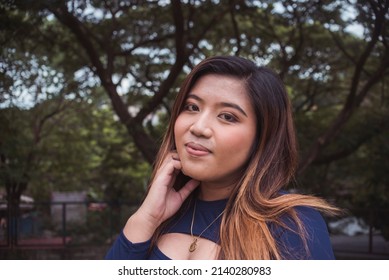 A Cute Young Woman In Happy Thoughts. Feeling Good About Her Glowing Skin And Looks. Confident By Her Positive Outlook In Life.