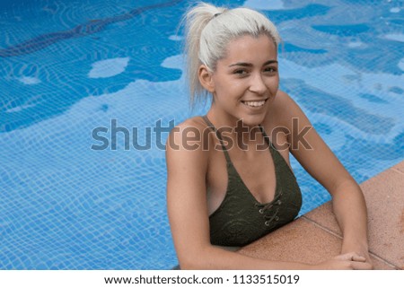 Cute young woman in pool