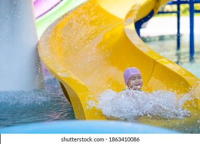 Cutel Little Girl Playing Waterslide At Waterpark.