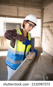 A Cute-looking Female Engineer From Asia Is Using An Electric Screwdriver And Wearing Personal Protective Equipment.
Worker Wear A Helmet, Hard Hat, Gloves, Safety Glasses.Work Safe Concept.Prevention