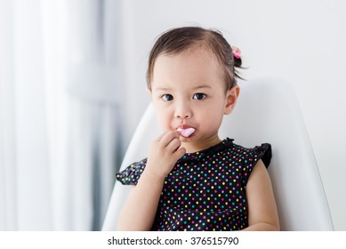 Cuter Asian Girl Eating Marshmellow At Home