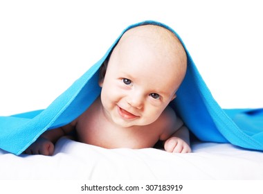 Cute,smiling, Happy Baby Under Blue Blanket Having Fun. Studio Indoors Shoot Isolated Over White Background.