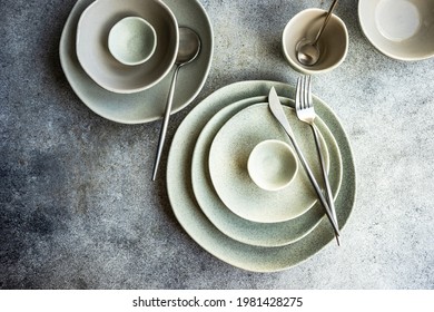 Cutlery And Dinnerware Set On Concrete Background