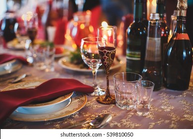 Cutlery and glasses. Dinner in the restaurant. Candles on the table. Banquet hall. The wedding feast