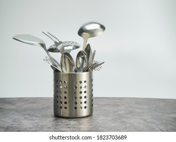 Cutlery holder, stainless steel on table against the white background - Powered by Shutterstock