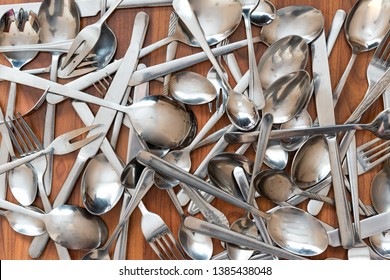 cutlery - knives, spoons and forks lie in disarray