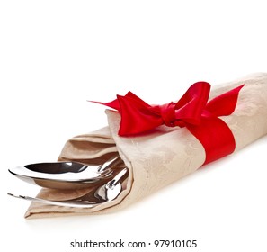 Cutlery And Napkin With Red Ribbon Bow Isolated On White