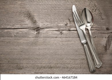 Cutlery is in a napkin wrapped on an old table