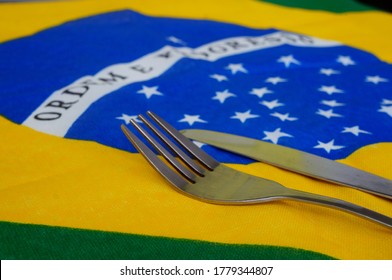 Cutlery On Top Of Brazilian Flag. Cuisine Of Brazil. Brazilian Food Concept.