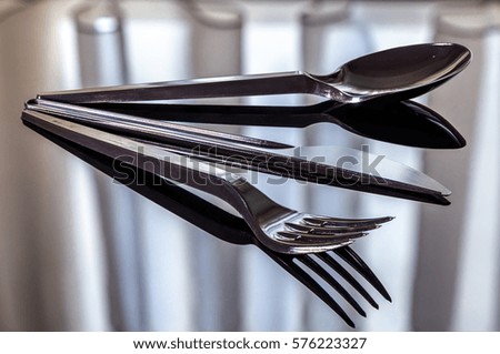 Cutlery plastic on the mirror surface
