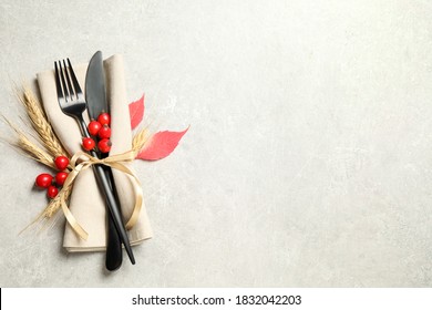 Cutlery, rosehip berries and napkin on light table, flat lay with space for text. Thanksgiving Day - Powered by Shutterstock