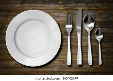 Cutlery Set With Fork, Knife, Spoon And Plate. Overhead View.