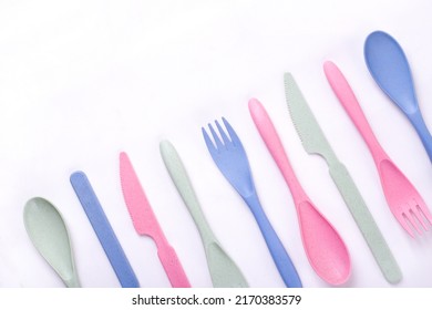 Cutlery Set Of Pastel Colors Made Of Wheat Straw In A Row On White Background. Reusable Utensils. School Lunch Concept