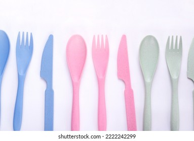 Cutlery Set Of Pastel Colors Made Of Wheat Straw In A Row On White Background. Reusable Utensils. School Lunch Concept