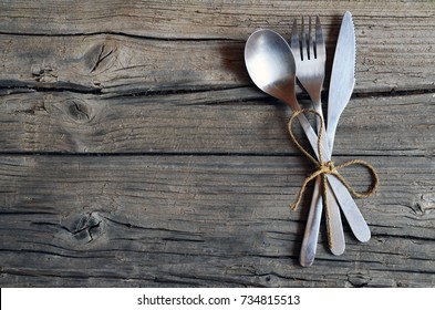 Cutlery set:fork,spoon and knife on rustic wooden table.Can be used as background menu for restaurant.Top view.Copy space.Selective focus. - Powered by Shutterstock