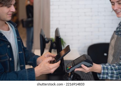 cutomer pay money by mobile payment with barcode scan at counter cashier in minimart store - Powered by Shutterstock