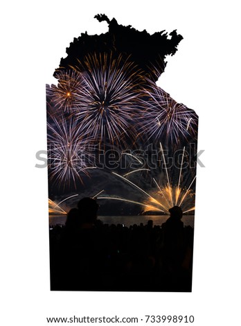 Cutout map of the Northern Territory, Australia showing fireworks with blurred people in foreground, part of celebrations at Mindil Beach, Darwin for Territory Day