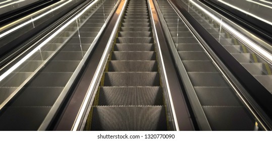 Cutout Of Multiple Escalators In A Train Station