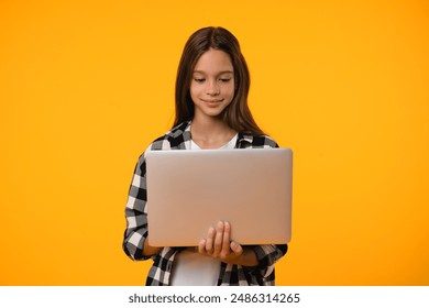 Cutout portrait of a young caucasian teenager student schoolgirl using laptop for e-learning, surfing Internet webpages, paying bills online, playing computer games isolated in yellow - Powered by Shutterstock