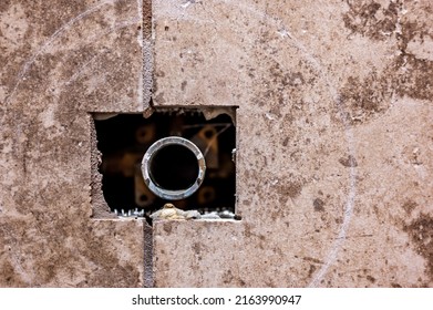 Cut-out section in bathroom shower tile with pipe connection protruding for water hookup.  - Shutterstock ID 2163990947