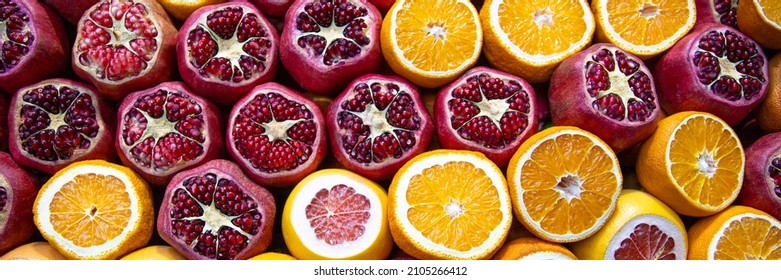 Cutted pomegranates, oranges and grapefruits on counter with street fresh juice. Red and orange fruits, front view. Real showcase with street food in Istanbul, Turkey. Web banner - Powered by Shutterstock