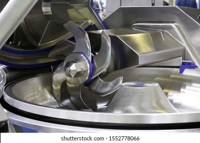 Cutter For Chopping Meat At A Meat Processing Plant. Industrial Cutter At The Factory Where Sausages Are Made. Huge Stainless-steel Pars For Meat Processing. Industrial Equipment. Food Industry.