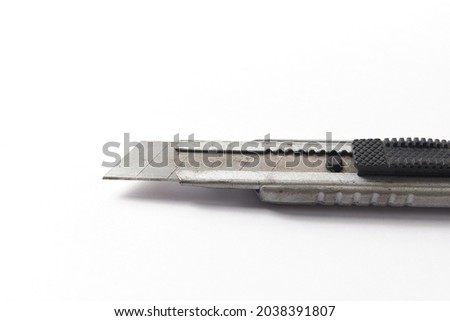 Cutter close up isolated on white, penknife used to open boxes or cardboard