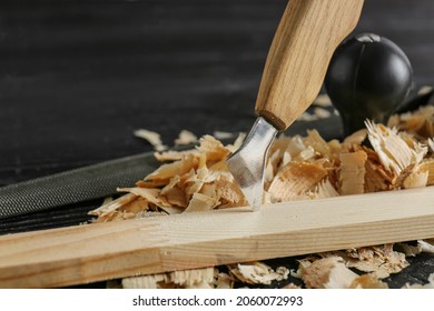 Cutter With Plank And Saw Dust On Dark Wooden Background, Closeup