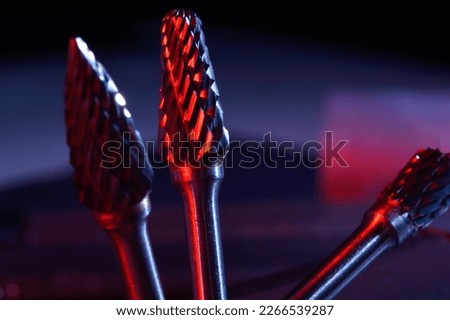 cutters of tungsten carbide on the background of metal blanks. Close-up
