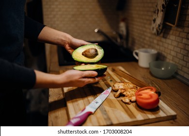 Cutting Up Avocado At Home Kitchen.Making Homemade Chicken Salad.Avocado Healthy Salad Ingredient.Healthy Keto/paleo Food Diet.Recipe For Guacamole Or Avocado Spread Cooking Process.Avocado Halves