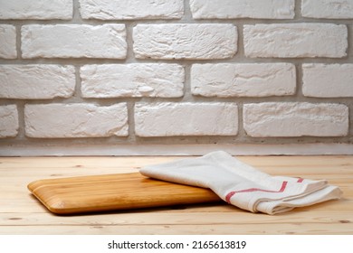 Cutting Board With Cotton Napkin On Wooden Table, Close Up