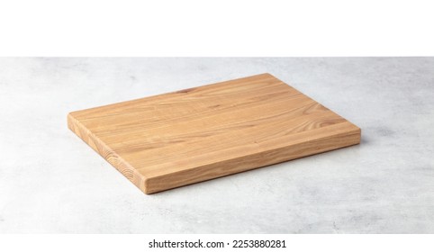 Cutting board on a grey stone table. Isolated on a white background. Culinary background. Empty wooden cutting board, product display space.