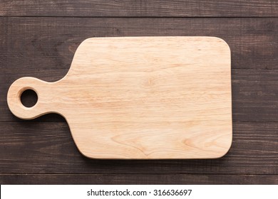 Cutting Board On The Wooden Background. Top View.